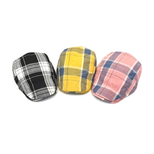 Detailed fabric texture of colorful plaid flat caps in vintage British style
