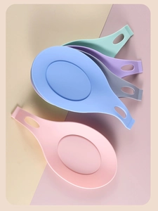 Macro shot of 4 colorful silicone spoon rests for kitchen utensil storage and organization