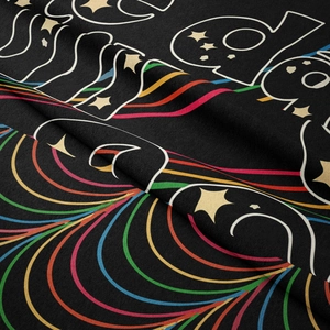Close-up of soft black tapestry fabric featuring a colorful rainbow and star pattern