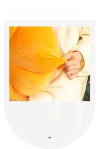 Close-up of orange pumpkin plush pillow featuring elastic fabric and striped texture details