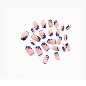 Short press-on nails with blue floral art and French tips on a natural pink base