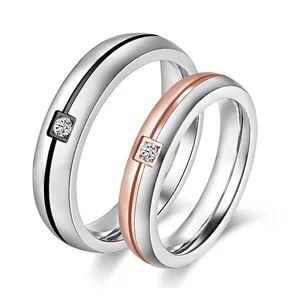 Minimalist two-tone stainless steel couple rings with central diamond accent