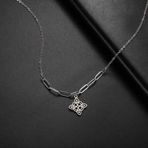 Detail of Celtic witch knot pendant on stainless steel paperclip and curb link chain