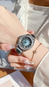Detail of Scottie women watch with crystal bezel and dark mother of pearl dial