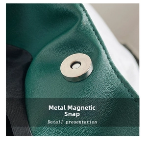 Close-up of secure silver magnetic buckle on dark green pebble leather tote bag