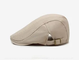 Detail of adjustable metal buckle and stitching on beige cotton beret cap