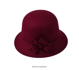 Detail view of burgundy wool felt cloche hat with stylish side bow decoration