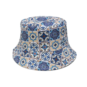 Bohemian bucket hat with blue and orange Mediterranean tile print on a white background