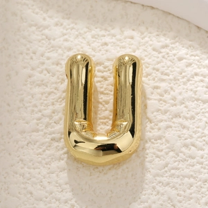 Polished gold plated letter U pendant with a puffy bubble design on a textured base