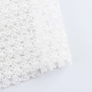 White mesh knit dress detail showing textured hollow-out crochet pattern fabric
