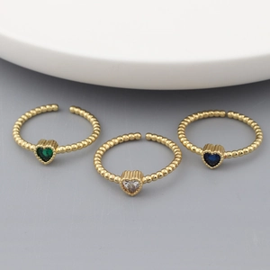 Three 18k gold plated heart-shaped rings with colorful zircon stones in a stylish display