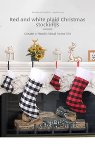 Classic red and white plaid Christmas stockings hanging on a white fireplace mantel