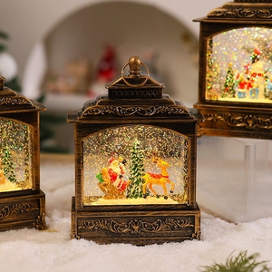 Macro shot of bronze Christmas snow globe lanterns with warm LED lights and glitter