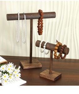 Detail of tiered vintage dark brown wooden T-bar jewelry stands for necklace display