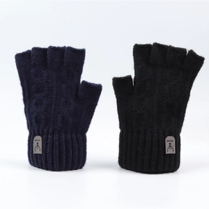 Close-up of winter knitted fingerless gloves with ribbed cuffs and decorative patch