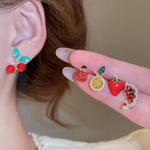 Macro shot of 10-piece crystal fruit stud earrings including cherry and strawberry