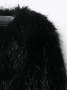 Close-up of premium black faux fur texture showing soft long plush fibers and high shine