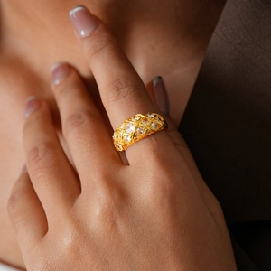 Detail of 24k gold plated geometric hollow grid ring with zircon inlays on model