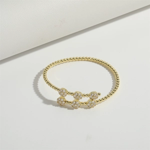 Luxury gold beaded open bracelet with micro-pave cubic zirconia on white background