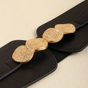 Detail of a black elastic waist belt featuring a textured gold metal interlocking buckle