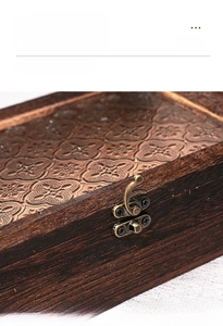 Detailed macro view of the vintage bronze alloy buckle on the wooden storage box