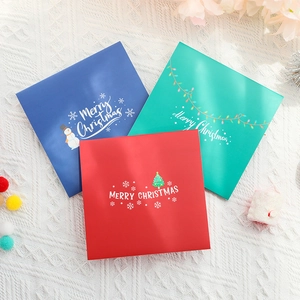 Three colorful 3D Christmas cards in red, blue, and green with festive holiday patterns