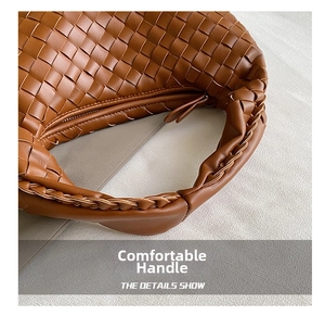Detail of caramel brown hand-woven leather handle and intricate knot texture