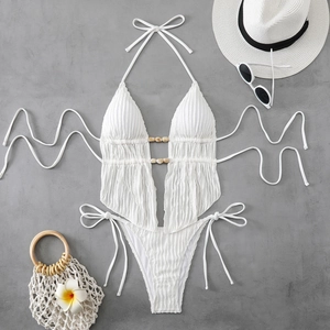 Flat lay of white textured halter bikini with wood bead detail and side-tie bottom