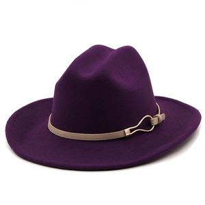 Detail of dark purple wool fedora hat featuring a beige strap and gold metal buckle