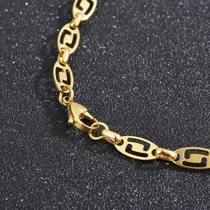 Macro view of gold stainless steel hollow oval links and lobster clasp on necklace