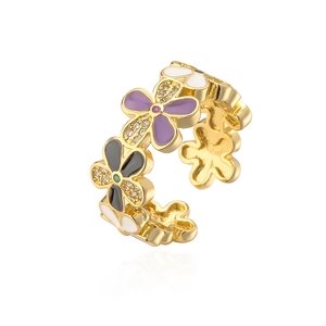 Detailed view of irregular flower ring with colorful enamel and zircon stones