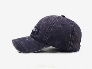 Side view of retro washed denim baseball cap with embroidered letters and vintage details