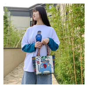 Ethnic style woven handbag featuring elephant and owl embroidery for daily use