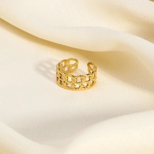 Detailed close-up of a double-layer gold ring with Cuban chain and hollow star design