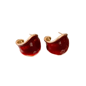 Vintage red enamel C-shaped wide earrings with gold plating on a clean white background