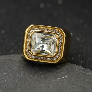 Macro view of gold signet ring with large rectangular zircon and micro-pave setting
