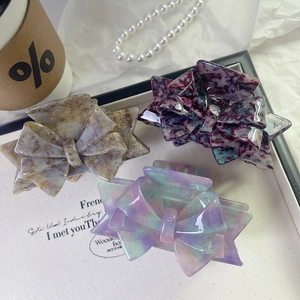 Elegant bow-shaped acetate hair claws with marble texture in three assorted colors