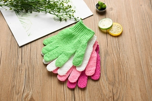 Detailed texture of colorful nylon exfoliating gloves on a natural wooden background