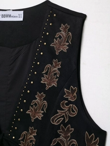 Detailed embroidery and gold rivets on black suede vest with V-neck collar detail