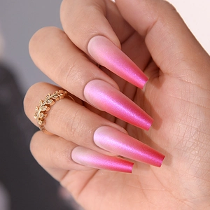Long coffin shape fake nails with glossy pink gradient finish and pearl shimmer effect
