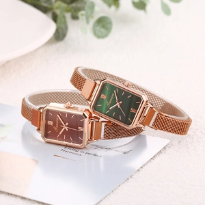 Detail view of square women watches with emerald green and brown dials in rose gold mesh band