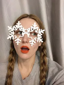 White snowflake party glasses for Christmas celebrations worn by a person