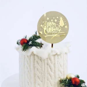 Golden acrylic Merry Christmas cake topper with festive tree and star patterns