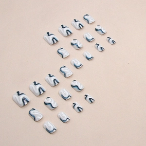 Short square press-on nails with blue and white abstract wavy patterns, full set layout