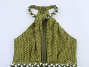Detail of green knit halter top with fringe trim and hidden zipper back closure