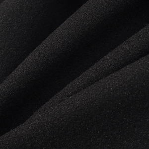 Close-up of high-density black wool-like textile fabric with fine grain and soft texture