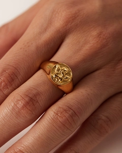 Macro shot of 18k gold plated ring featuring a vintage angel relief on a circular face