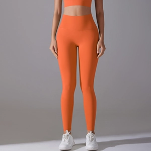 Detailed side view of high-waisted orange yoga pants with seamless athletic fabric