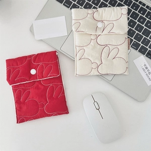 Close-up of quilted sanitary pouch set with cute rabbit embroidery and snap closure