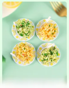 Miniature fried rice food models with white plates and spoons on mint green background